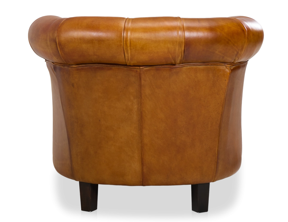 Sillón chesterfield de piel cognac reposabrazos con tachuelas