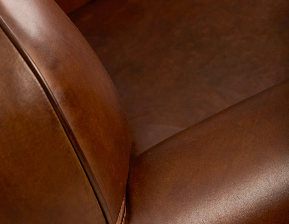 Fauteuil club cuir marron vintage accoudoirs passepoil