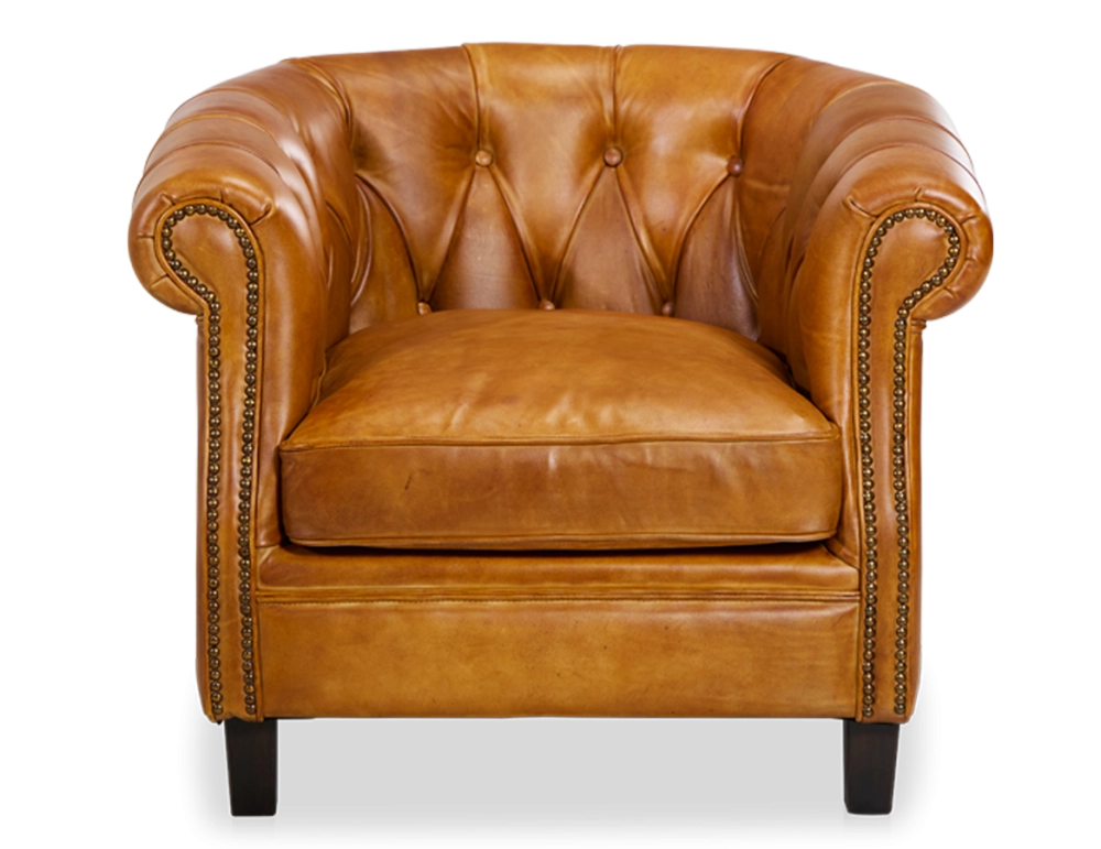 Sillón chesterfield de piel cognac reposabrazos con tachuelas