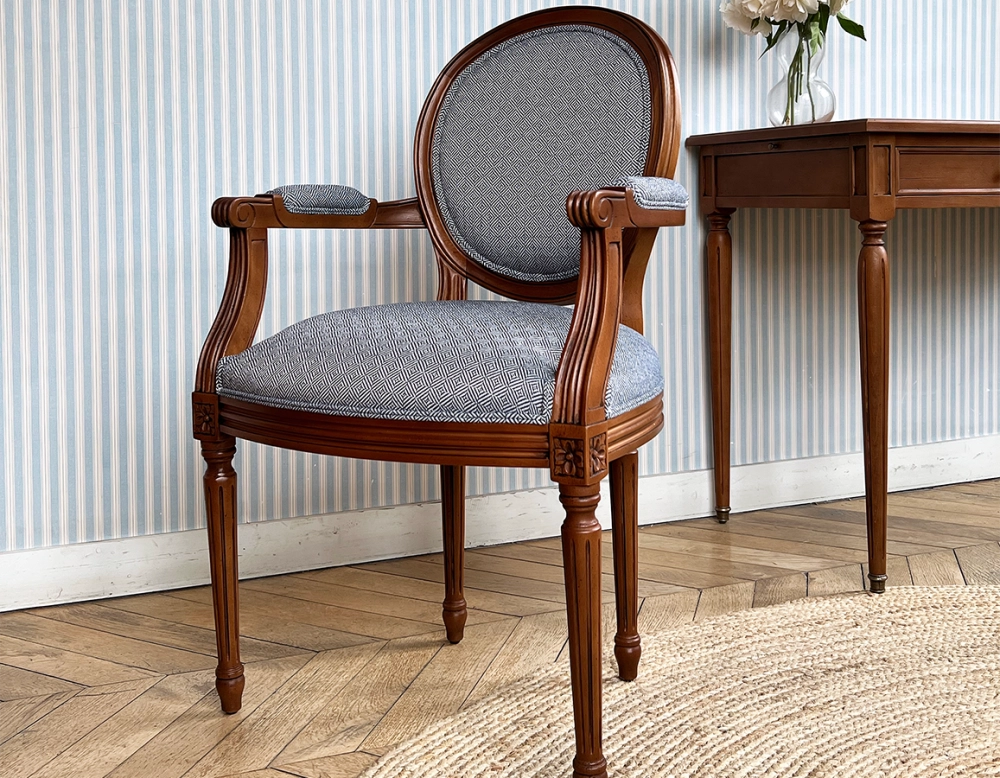 Antique Louis XVI style armchair with armrests aged wood stain and blue chevron fabric