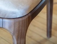 Designer chair dark brown stained wood and light taupe velvet fabric