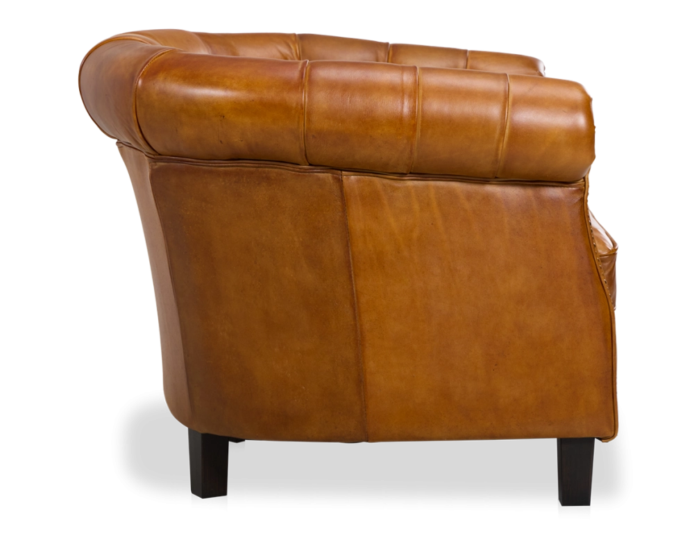 Sillón chesterfield de piel cognac reposabrazos con tachuelas