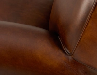 Fauteuil club cuir marron vintage accoudoirs passepoil