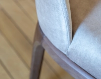 Designer chair dark brown stained wood and light taupe velvet fabric