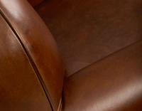 Fauteuil club cuir marron vintage accoudoirs passepoil
