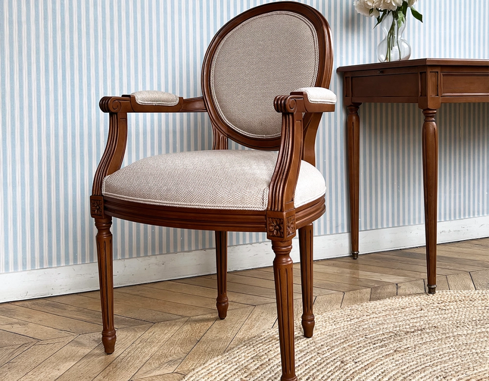 Antique Louis XVI style armchair with armrests wood stained in antique style and beige chevron fabric