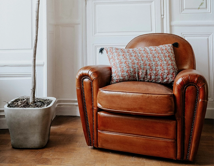 Sillón club de piel marrón claro reposabrazos con tachuelas